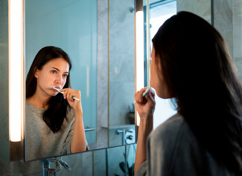 Woman Brushing Her Teeth - Absolute Smile
