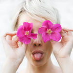 Girl Covering Face With Sunflower - Absolute Smile