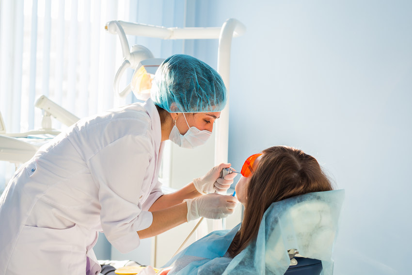 Young Woman Getting Dental Treatment Dental - Absolute Smile
