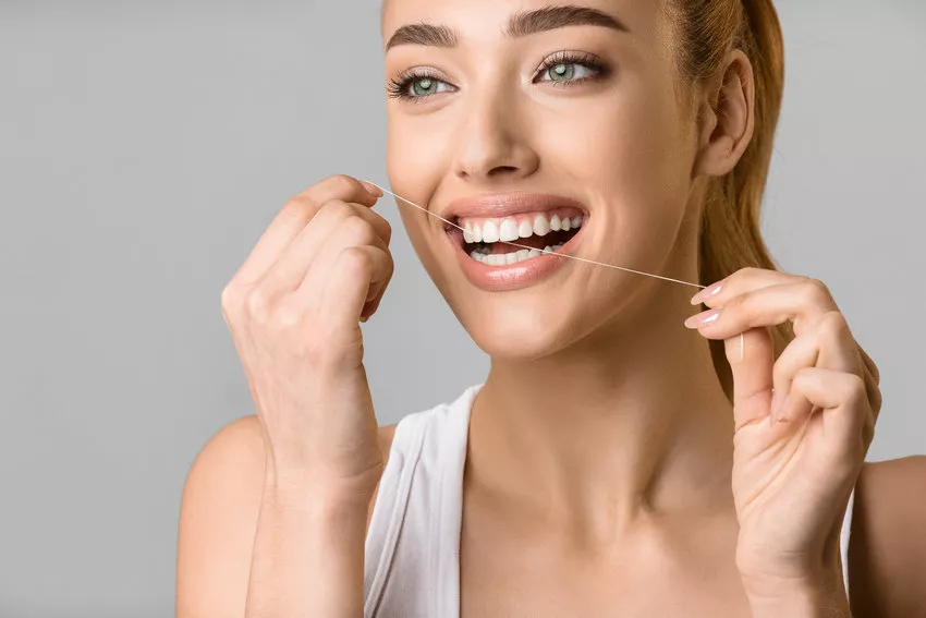 woman flossing her teeth
