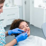 Dentist with patient in dental clinic smiling and discussing care