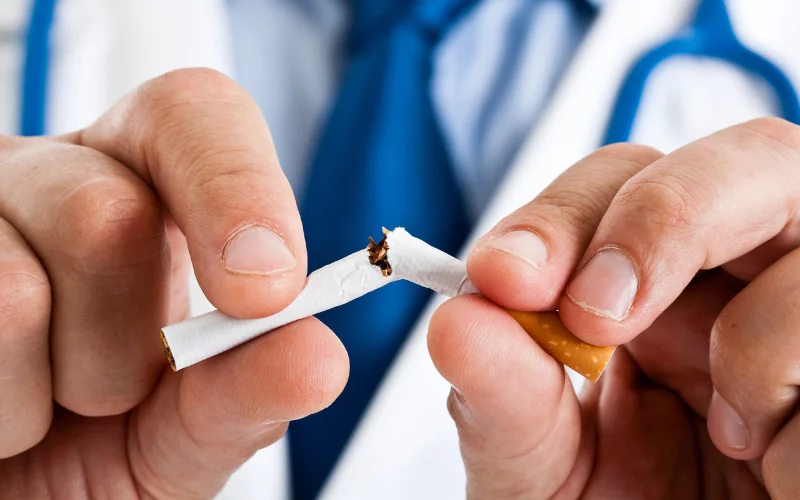 Doctor breaking cigarette for healthy lifestyle choice