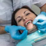 Dentist examining patient's teeth for color matching