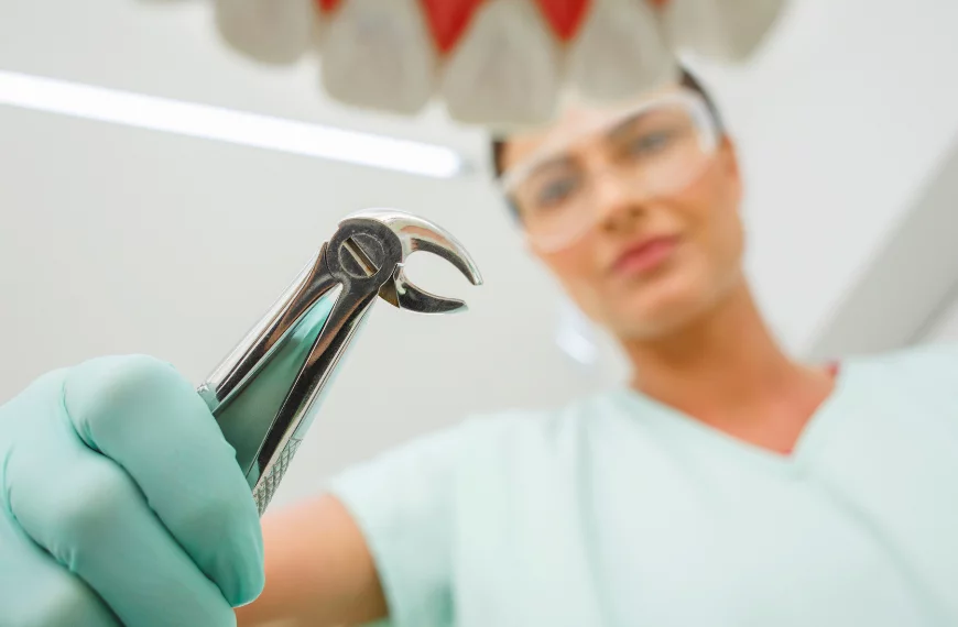 dentist holding tooth extraction forceps