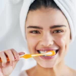 smiling woman brushing teeth