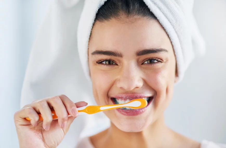 smiling woman brushing teeth